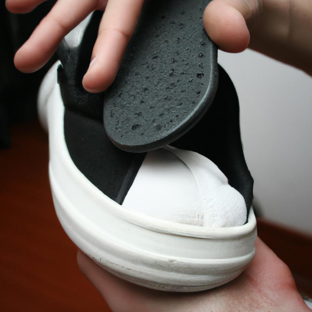 Person inserting insole into shoe